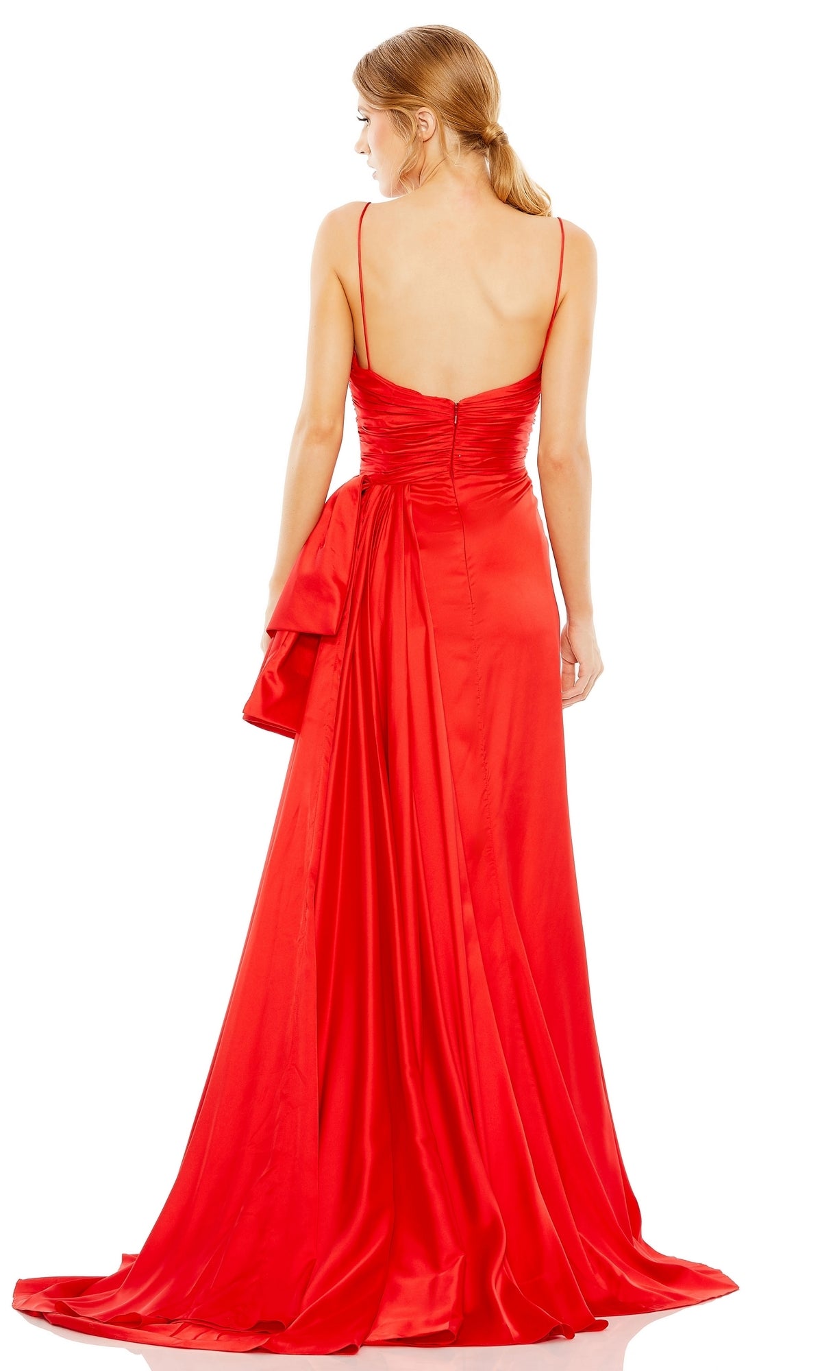 A woman faces away from the camera, wearing the Long Formal Dress 68450 by Mac Duggal—a floor-length red satin gown with thin straps, a ruched sweetheart bodice and back, and holding a matching fabric accessory.
